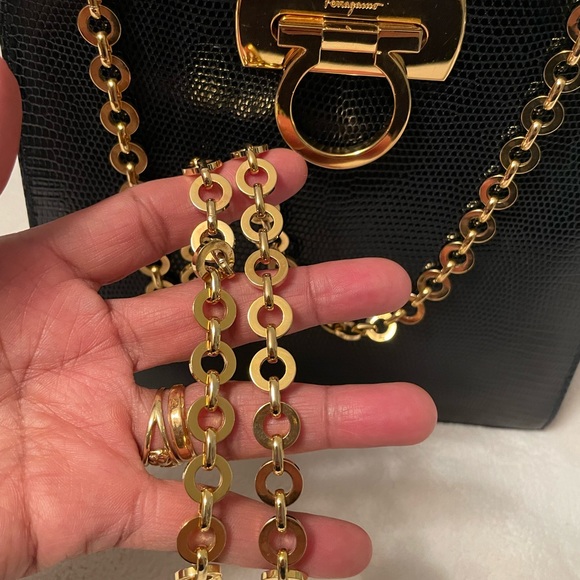 Authentic Salvatore Ferragamo black leather bag with shiny gold metal handle. - Picture 3 of 11